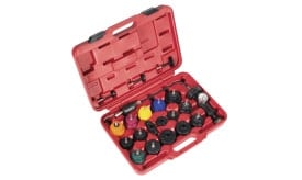 Comprehensive valve spring tool kit with various coloured caps and pressure gauge in a red case for automotive repairs.