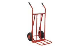 Heavy-duty red hand truck with large wheels for transporting goods easily and efficiently.