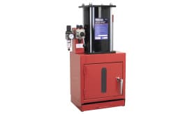 3-station pneumatic grease pump with a red base and black tank, featuring a pressure gauge and storage compartment.