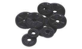 A collection of assorted black plastic gears in various sizes, showcasing intricate teeth and central holes for mechanical applications.