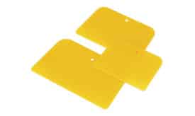 Three yellow silicone scrapers in varying sizes, ideal for kitchen use and food preparation.