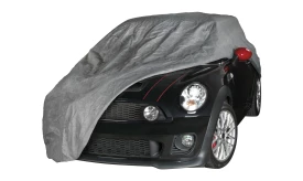 Grey car cover draped over a Mini Cooper S, protecting it from dust and debris.