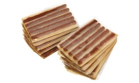 Assorted fruit leather strips packaged in multiple layers, showcasing various flavours and textures, ideal for healthy snacking.