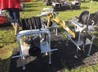 Industrial hose reel equipment with hoses and fittings on display, showcasing durable construction and functionality for various applications.